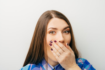 woman with hand over her mouth