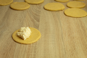 Woman cuts dough pieces for baking