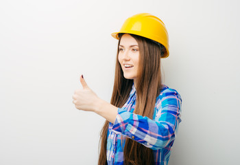 girl in the construction helmet showing thumbs up