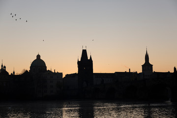 Prague skyline silhouette during sunset, orange and blue colors