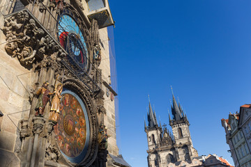 Fototapeta na wymiar Prague church clock, old clock, blue sky, historical buildings