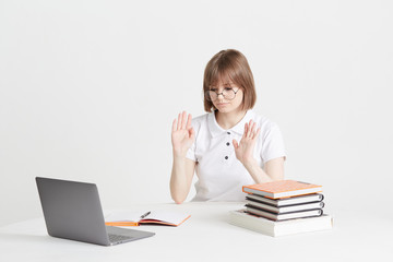 Cool happy girl goes through online training sitting at home. Remote school education on a laptop. Stay home lessons.