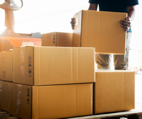 Workers Lifting Packaging Boxes on Pallet. Cardboard Boxes. Shipping Supplies Warehouse. Shipment...