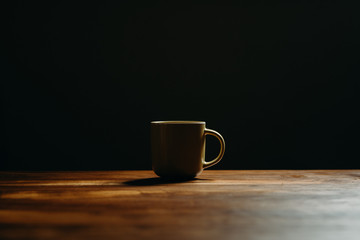 Coffee cup on  wooden table in livingroom. Background with free text space.