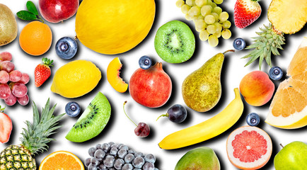 Creative photo of many different exotic tropical bright fruits with shadows on a white background. View from above. Bright summer fruit pattern.