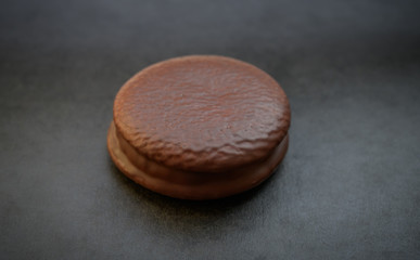 Chocolate cookie on a dark background. Natural light. Selective focus.