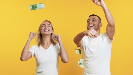 Surprised happy couple enjoying money rain banknotes falling down. Success, business, and fortune concept. Slow motion