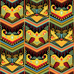 Colorful Ikat seamless background with stylized birds and chevrons.