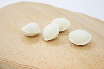 Fototapeta na wymiar Delicious fresh frozen dumplings located on the cutting board