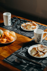 Breakfast setting for two people - Coffee, Tea, Breads and fruits.