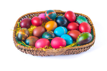 Fototapeta na wymiar Colorful easter eggs in basket isolated on white background