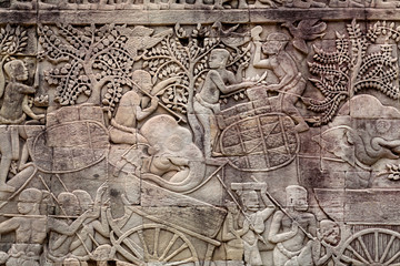 Fototapeta na wymiar Workers of ancient farms, stone relief from the 12th century Bayon temple, Cambodia. Historical artwork on wall of Khmer landmark in Angkor