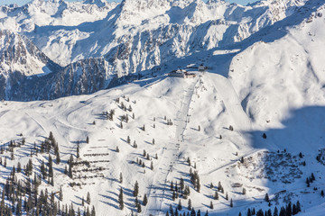 Fototapeta na wymiar ski slopes and lifts in the Montafon ski area, Vorarlberg, Austria during winter season - aerial view