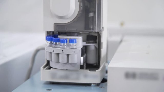 Laboratory of food industry measurement of alcoholic beverages production parameters in flasks and test tubes. Automated laboratory machine for experiments.