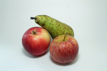 Red apples and a pear isolated on a white background