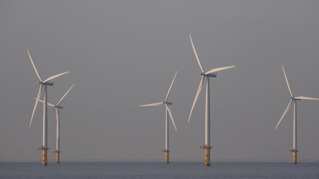 Offshore wind turbine farm off teesside North east England UK 4K