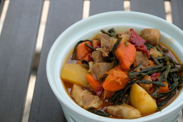 close up beef stew with potato and carrot in white pot on table. Chinese cuisine