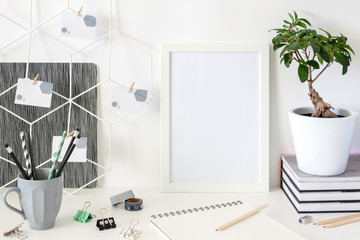 Creative desk at home against a white wall background. Mockup frame.