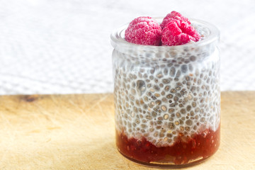 Homemade Chia Pudding with Raspberry in Transparent Glass.