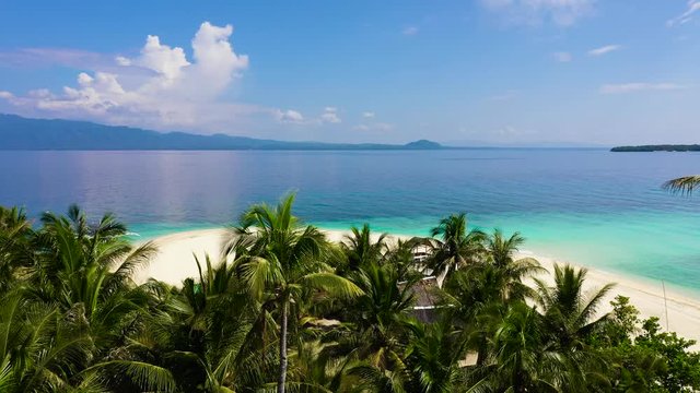 Summer beach landscape. Tropical island view, palm trees with amazing blue sea. Digyo Island, Philippines. Island with a tropical beach and turquoise lagoons.