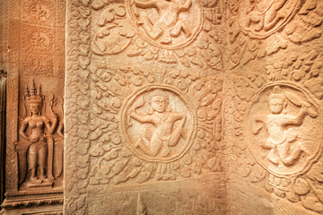 Historical patterns with dancers and Apsara women on reliefs of Angkor What temple, 12th century Khmer landmark. Cambodian complex and UNESCO World Heritage Site