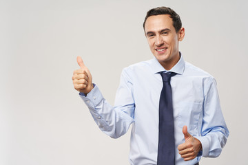 young businessman showing thumbs up