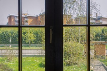 Window to outdoors: view on empty street and nature during quarantine
