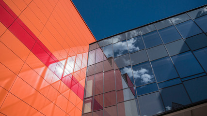 fragment of the colored facade of the building against the sky