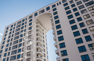 facade of a residential building with arch fragment low angle view against the sky