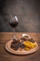 Steak with grilled vegetables and seasoning on serving plate