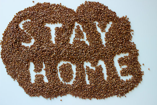 Stay At Home message made of buckwheat on white background. Motivation quote Stay At Home for stay-at-home order mode. isolated