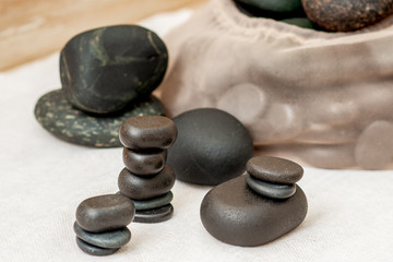 Set of stacks hot massage stones on towel in spa.