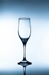 Empty glass goblet on gradient background