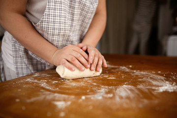 Children's hands make a dough. help mom