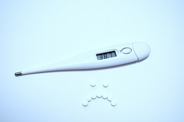 Body thermometer with high temperature and pills in shape of sad smile
