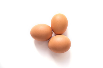 Three brown eggs isolated on the white background.