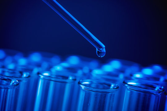 Test Tube Row. Concept Of Medical Or Science Laboratory, Liquid Drop Droplet With Dropper In Blue Tone Background, Close Up, Micro Photography Picture.