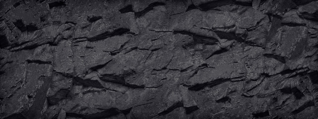 Black and white background. Stone texture. Black grunge background. Black banner with rock texture.