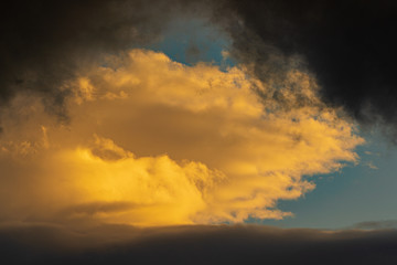 Dramatic clouds illuminated rising of sun floating blue sky. Natural weather, meteorology background. Heavenly landscape image ready for design, replace sky in photo editor. Soft focus, blurred motion