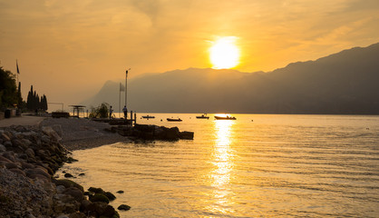 Fototapeta na wymiar Beautful coastline of Garda lake at sunset, northern Italy