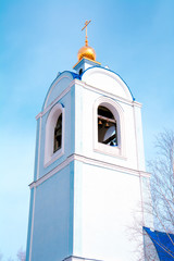 Church Bell Tower, snow-white Church, Orthodox Church, Golden domes, against the blue sky