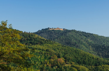 The monastery Eremo del Monte Rua on the top of the hill. Italy. Soft focus, blurry background.