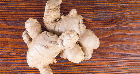 Fresh ginger root on wooden table
