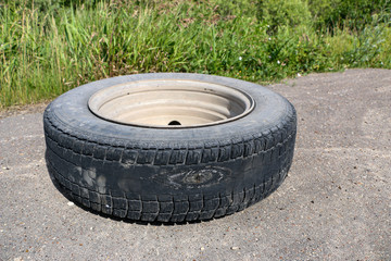 rubbed wheel of  lorry. worn wheel with  hole in  tire, worn rubber tread to  cord