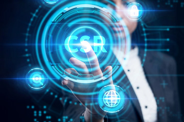 Business, Technology, Internet and network concept. Young businessman working on a virtual screen of the future and sees the inscription: CSR