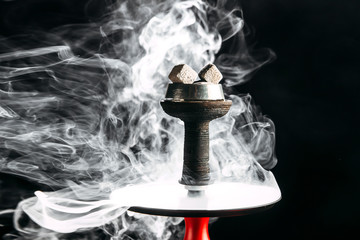 steaming hookah with a red pipe on a black background, horizontal, side view