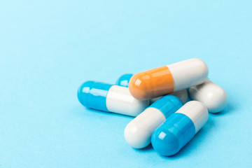 Pills isolated on blue background.Colorful medical drug capsule.