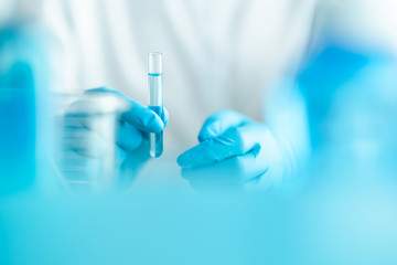 scientist holding test tube, lab testing for inventing pandemic medication