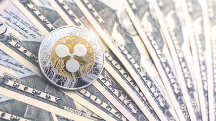 Physical version of Ripple and dollar banknotes. Exchange xrp for a dollar symbol. Conceptual image for worldwide cryptocurrency and digital payment system.