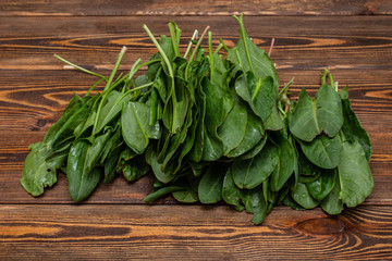 Fresh organic culinary herbs . Wooden plank with green leaves . 